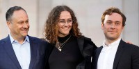 Doug Emhoff, Ella and Cole smile standing next to each other