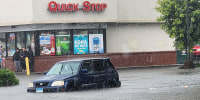 A car is partially submerged following a flash flood in Danbury, Connecticut. 