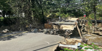 Image: rain storm aftermath bridge washed out