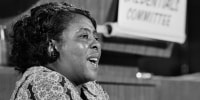 Fanny Lou Hamer speaks while seated at a table