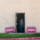 "Vote Here" signs outside library building. 