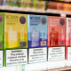 Varieties of disposable flavored electronic cigarette devices on a store shelf